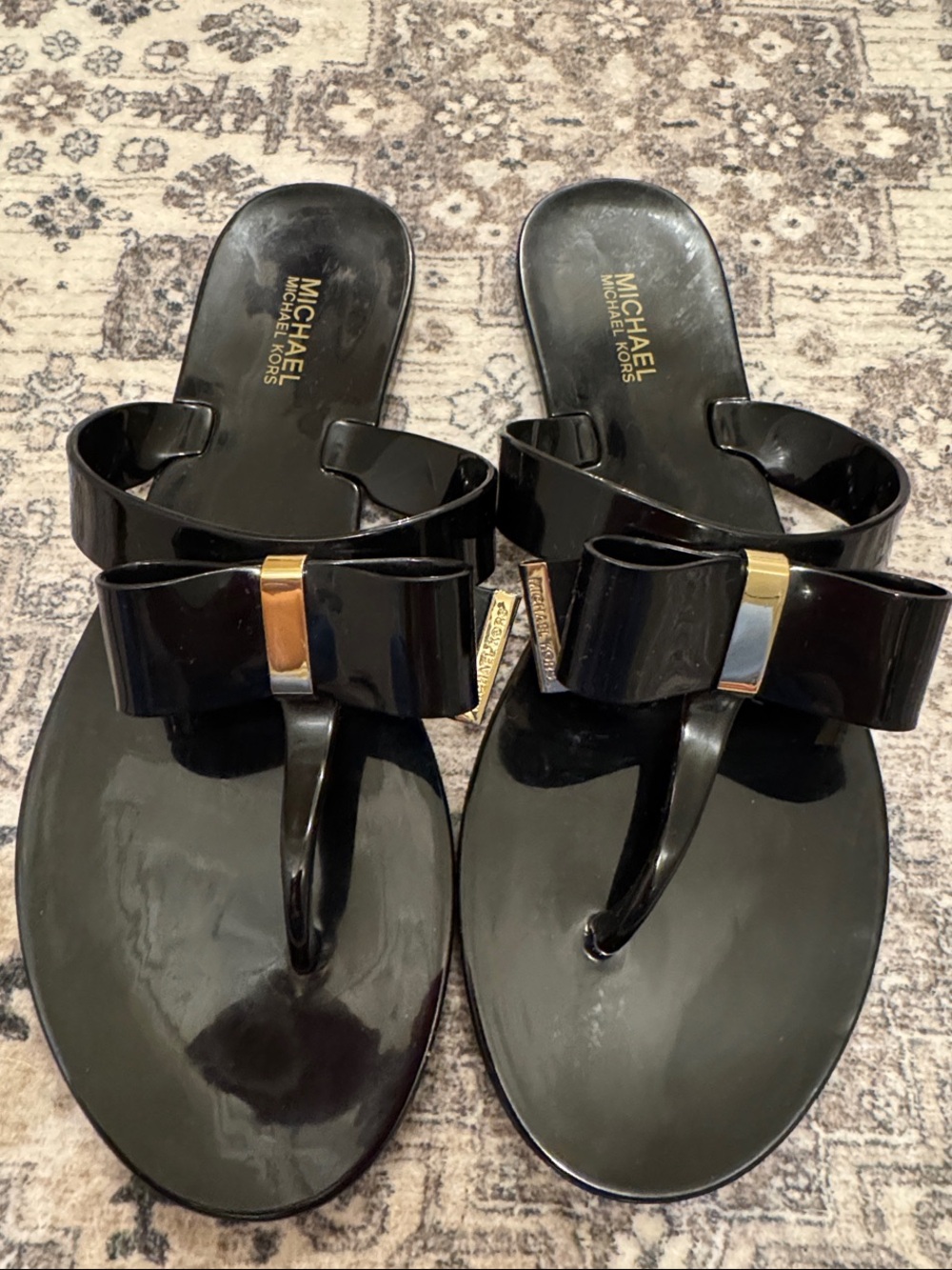 MICHAEL Michael Kors Black Patent Bow Thong Sandals with Gold Accent
